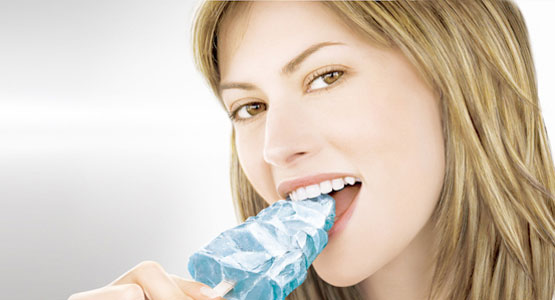 denti-sensibili donna che morde un cubetto di ghiaccio