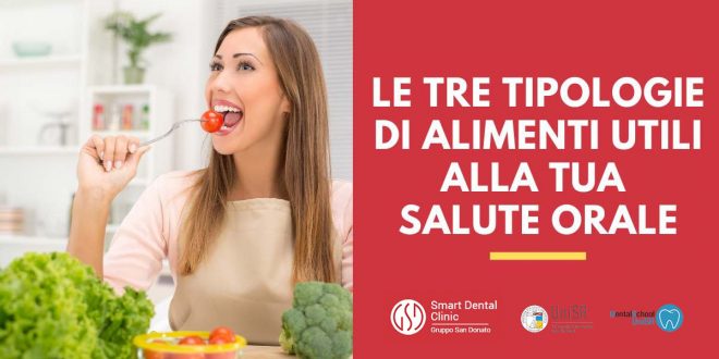 alimenti-utili-salute-orale-1 Ragazza seduta a tavola che sta per mangiare un pomodoro